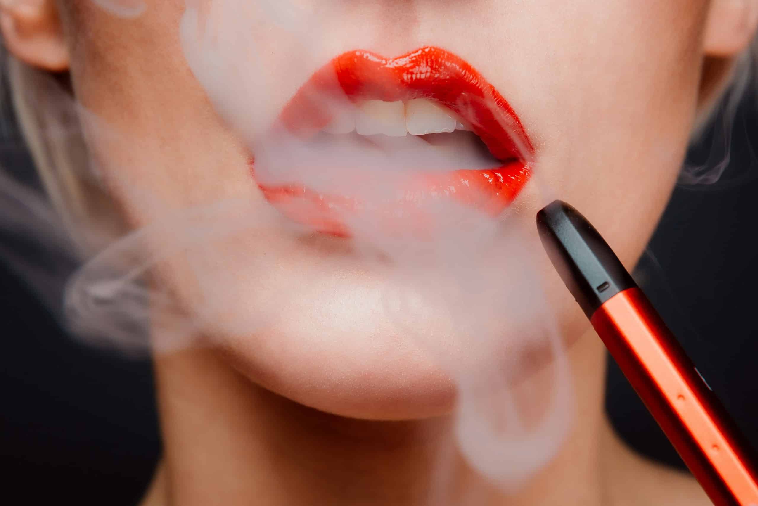 a lady in red lips smoking elf bar thc 