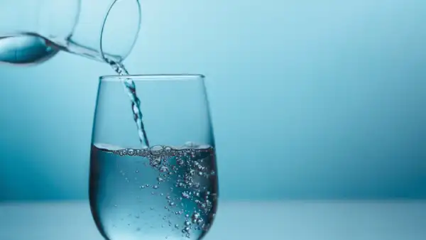 Fresh water being poured into a glass cup